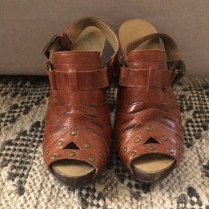 Leather studded platform mules.